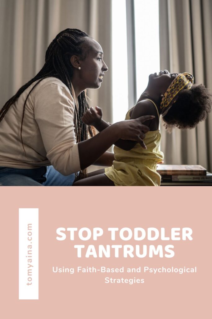 A toddler throwing a tantrum with mom holding to calm the toddler down